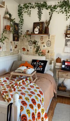 a bedroom with lots of plants growing on the wall above the bed and in front of it is a trick or treat sign