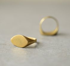 Gold signet ring, hand made of brass and gold plated in 22k gold size of this ring is 6 (US size) if you need different size let me know, I'll be happy to make you a custom order. it can take 7-14 days to be made can also be made in 14k/18k/22k solid gold, for prices convo me similar ring available in 14k gold: https://www.etsy.com/il-en/listing/161747210/antique-gold-ring-14k-gold-ring-signet?ref=shop_home_active_23 and in sterling silver: https://www.etsy.com/il-en/listing/168485588/silver-twi Matte Gold Brass Rings As Gifts, Matte Gold Brass Rings For Gift, Gold Brass Engraved Ring For Promise, Matte Gold 14k Gold Rings For Gift, Matte Gold 14k Rings For Gifts, Minimalist Gold Brass Rings, Minimalist Engraved Gold Ring In Recycled Gold, Gold Brass Rings As Gifts, Brass Rings With Polished Finish For Wedding