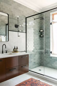 a bathroom with a sink, mirror and shower stall in front of a large window