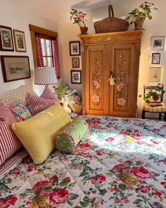 a bed room with a neatly made bed and lots of pictures on the wall above it