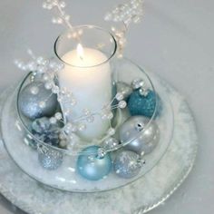 a candle and some ornaments on a plate