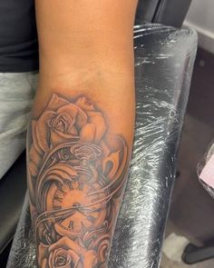 a person with a rose tattoo on their arm