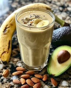 an avocado, banana, and milkshake are on the counter top