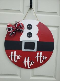 a door hanger with a santa clause hat on it that says, ho ho ho