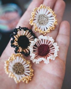 three different types of brooches in someone's hand