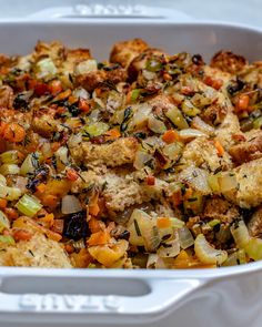 a casserole dish filled with stuffing and vegetables