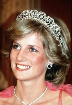 a woman wearing a tiara and smiling at the camera