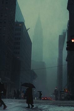 people walking in the rain with umbrellas on a city street near tall buildings and skyscrapers