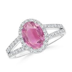 The dramatic pink hue of the prong set oval pink tourmaline is truly captivating. It is encircled by a glimmering halo of diamonds, enhancing the luxurious look of this vintage inspired ring. Also, the diamond accents on the split shank and the detailing on the gallery infuse a hint of opulence to this striking platinum oval pink tourmaline ring. Pink Tourmaline Engagement Ring, Vintage Inspired Rings, Pink Tourmaline Ring, Tourmaline Ring, Split Shank, Pink Ring, Halo Ring, Pink Tourmaline, The Gallery