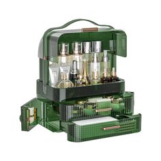 an open green cosmetic case filled with lots of bottles and other items on top of it