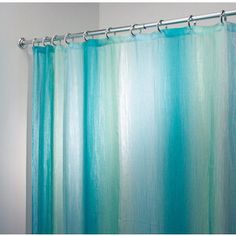 a shower curtain with blue and green stripes on the bottom, in front of a white background