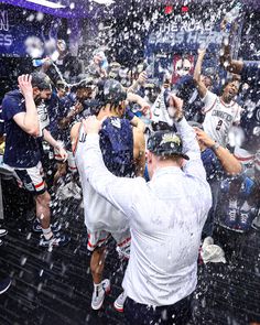 the soccer team is celebrating with their trophy and confetti in front of them