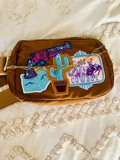 This water resistant patch crossbody/ waist bag is perfect for everyday use.  One- of-kind.  Hand selected premium patches. Gold hardware with bag chain.  Take it to the lake, beach or on a hike.  Hand wash inside out. Iron On Patches Ideas Bags, Bag With Patches, Coors Cowboy, Patch Hats, Sublimation Ideas Projects Inspiration