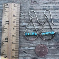 These chandelier earrings are handmade from genuine turquoise and sterling silver. The small natural stones are framed by hammered curves which I have formed and textured by hand. The turquoise beads and hammered curves dangle from sterling silver chains and earwires. Silver has been oxidized and polished to create an antique patina finish. Be sure to see all photos and video for size and color reference. Turquoise Beads: About 2x4mmTotal Earring Length (including earwire): About 1 and 7/8"Total Earring Weight: About 1.9 grams per one earring Turquoise Teardrop Chandelier Earrings In Sterling Silver, Turquoise Soldered Sterling Silver Earrings, Handmade Turquoise Chandelier Earrings In Sterling Silver, Turquoise Sterling Silver Chandelier Earrings, Turquoise Sterling Silver Dangle Chandelier Earrings, Nickel-free Sterling Silver Turquoise Chandelier Earrings, Hand Forged Turquoise Sterling Silver Earrings, Silver Chandelier Earrings, Silver Chandelier