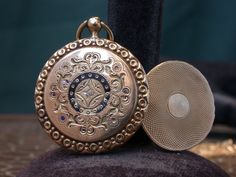 "WE SELL THIS NICE VICTORIAN PHOTO LOCKET MEDAL PENDANT MADE IN 9K GOLD DECORATED WITH ENAMEL AND 1 LITTLE GENUINE DIAMOND ,IN GOOD CONDITION ,HAS SOME SIGNS OF WEAR COMMENSURATE WITH AGE AND USE , PLEASE SEE PICTURES, MAYBE NEEDS SOME CLEANNING, PLEASE SEE PICTURES, OPEN AND CLOSE WELL,SOME ENAMEL IS MISSING, PLEASE SEE PICTURES, the measures are 1\" diameter X 1 1/2\" total long WEIGHT 5.5gr As is a vintage antique item , it's unique , for that if you like to wear it , don't miss the opportuni Elegant Compact Locket Jewelry, Antique Bronze Pocket Watch With Locket, Victorian Antique Gold Pocket Watch Gift, Victorian Pocket Watch In Antique Gold As Gift, Victorian Antique Gold Pocket Watch For Gift, Antique Screw Back Jewelry For Gift, Antique Jewelry With Screw Back For Gift, Vintage Medallion Pocket Watch For Wedding, Vintage Medallion Pocket Watch For Weddings