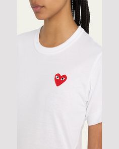 Comme des Garcons Play tshirt with almondeyed heart logo appliqué at left    Crew neckline    Short sleeves    Relaxed fit    Straight hem    Pullover style    Cotton    Made in Japan Spring Heart Graphic T-shirt, Trendy Tops With Embroidered Logo, Casual Crew Neck T-shirt With Heart Patch, Casual Fitted T-shirt With Embroidered Logo, Embroidered Logo Tops For Summer, Casual Cotton T-shirt With Heart Patch, Cotton Graphic Tee With Heart Patch, Spring Heart Patch Crew Neck Top, Spring Crew Neck Top With Heart Patch