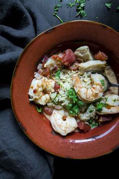 a red bowl filled with shrimp and rice