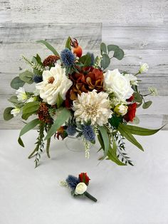 a vase filled with white and red flowers