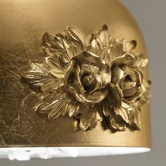 an ornate gold plate with flowers on it