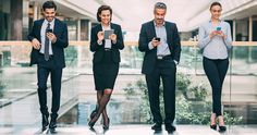 three business people looking at their cell phones