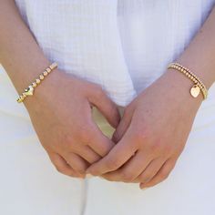 A classic statement piece from the Beaded Lux collection with a little bit of love! 6mm sterling silver or 14k gold filled beads with a sterling silver heart in the center. Easy wear and effortless stacking with sturdy stretch cord design. Sizing options to make a perfect fit. Every Jewel Ya design comes in our signature acrylic storage container for air tight storage. Elegant Gold Stretch Bracelet With Heart Beads, Everyday Beaded Heart Bracelet, Everyday Jewelry With Heart Charm And Round Beads, Elegant Stretch Bracelet With Heart Charm, Dainty Beaded Bracelets With Heart Charm, Dainty Everyday Beaded Bracelets With Heart Charm, Elegant Stretch Bracelet With Heart Beads, Everyday Gold Beaded Bracelets With Heart Charm, Everyday Heart Bracelet With Round Beads