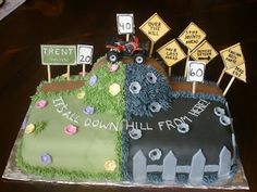 there is a cake that has been decorated to look like a race track and road signs