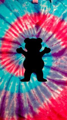 a tie - dyed shirt with a teddy bear cutout on it