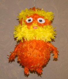 an orange and yellow stuffed animal hanging from a string