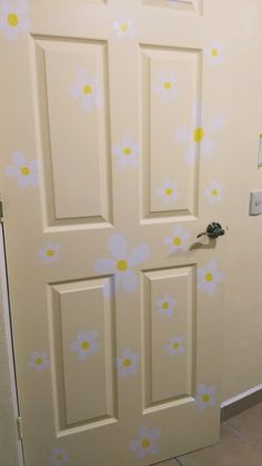 a white door with yellow and blue flowers painted on it