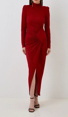 a woman is wearing a red dress and heels