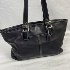 Buttery soft Coach Hampton 5246 Black Leather Large Tote Shoulder Bag measuring about 15" x 10" x 4.5" with dual Handles with a 9.5" strap drop Missing 1 grommet and a little wear on one strap, a little wrinkling of the leather on one side, very slight wear in a couple of places on the bottom, and a few small spots inside - see photos And although this might seem like a long list of what's wrong, I was just trying to be extras thorough. This is a beautiful bag with pretty slight overall wear. Or Coach Medium Leather Shoulder Bag, Medium Black Shoulder Bag With Handles, Elegant Medium Black Bag, Elegant Black Medium-sized Bag, Classic Satchel With Snap Closure, Black Faux Leather Bag With Silver-tone Hardware, Casual Coach Rectangular Shoulder Bag, Casual Rectangular Coach Shoulder Bag, Formal Satchel With Snap Closure