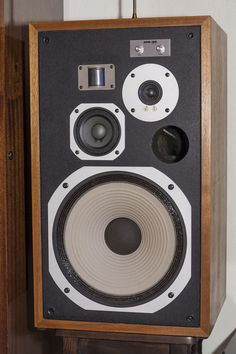 an old fashioned speaker hanging on the wall