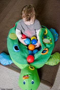 a toddler playing with toys on the floor