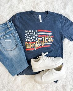 an american flag t - shirt, jeans and sneakers are laid out on a white carpet