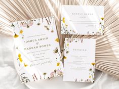 the wedding stationery is laid out on a white plate with gold foil and flowers