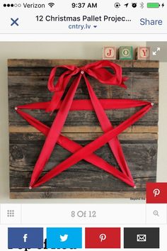 a wooden star with red ribbon tied around it