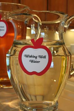 two glass pitchers filled with liquid sitting on top of a counter