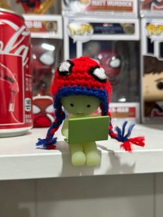 there is a small toy with a red and blue hat on it's head