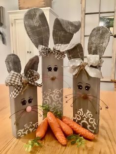 some carrots are laying on the table next to small bags with faces and ears