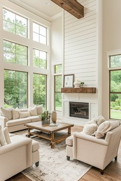 a living room with couches, chairs and a coffee table in front of large windows