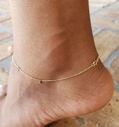 Letter anklet designed for a delicate or minimalist style you. Matching with all day or night styles. You are able to add a letter from the drop down. Initial anklet comes as a center style.( I have other style as a sideways available in my shop) feel free to check it out. Good tip: please be careful with this beautiful anklet if you are planing to wear a pants or shoe with a ankle tie. Gold initial anklet is very delicate and should withstand a normal wear. This anklet is not for kids or teenag Gold Delicate Anklet For Gift, Delicate Gold Anklets As Gift, Dainty Hypoallergenic Anklets For Everyday Use, Dainty Hypoallergenic Everyday Anklets, Delicate Yellow Gold Anklet As Gift, Minimalist Gold Anklets For Everyday, 14k Gold Anklets As Gift, Delicate Gold Anklet For Gift, Dainty Anklets With Adjustable Chain As Gift