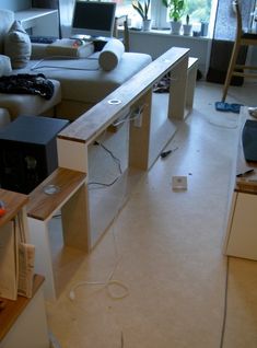 a living room filled with furniture and a laptop computer sitting on top of a desk