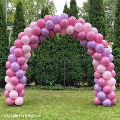 a pink and purple arch made out of balloons