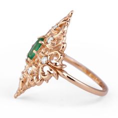 Feel free to contact us to make a custom order inquiry. Emerald Ring with diamonds is a beautiful creation in Yellow Gold embellished with classical ornamental leaves design, accented with Natural Zambian Faceted Emerald and White Diamonds. Materials: 14K Yellow Gold, 0.5ct Natural Faceted Emerald, 8 White Natural Diamonds totaling .24cts. Available in 14K and 18K Yellow Gold Fine Jewelry Green Emerald Ring With Single Cut Diamonds, Luxury Green Emerald Ring With Rose Cut Diamonds, Green Diamond Ring With Rose Cut Diamonds, Green Oval Diamond Ring With Single Cut, Green Oval Single Cut Diamond Rings, Green Rings With Rose Cut Diamonds, Art Deco Green Emerald Ring With Rose Cut Diamonds, Art Deco Emerald Ring With Rose Cut Diamonds, Fine Jewelry Yellow Gold Emerald Ring With Intricate Design