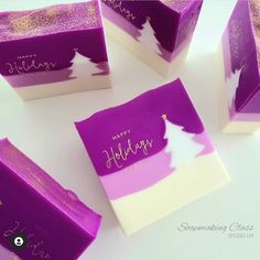 four purple and white boxes with happy holidays written on them