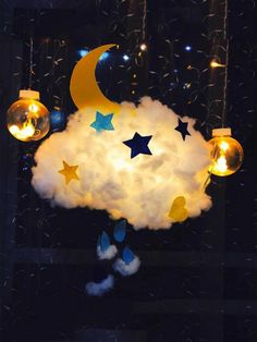 a cloud with stars and moon lights hanging from it