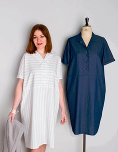 a woman standing next to a mannequin wearing a white and blue shirt dress