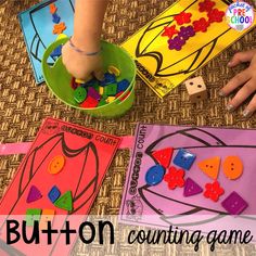 two children's hands playing with matching shapes and numbers on the floor in front of them