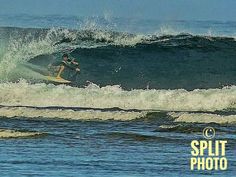 a man riding a wave on top of a surfboard