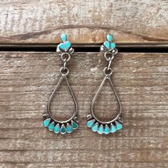 These beautiful Dishta style drop earrings are not only delicate but elegant in the way that many Dishta jewelry pieces are. Each piece of beautiful natural turquoise is cut into a teardrop shape and then fan the base of the silver wire drop and then clustered on the stud. The earrings are unsigned and are 1 7/8 inches in length and approximately 5/8 inch wide.  We try to represent color as accurately as possible in our photographs. However, color may vary from screen to screen. Please let us know if you have any questions before placing an order. All of our items are shipped via USPS Priority mail and insured. Southwestern Style Teardrop Dangle Earrings, Southwestern Turquoise Teardrop Earrings, Turquoise Sterling Silver Teardrop Dangle Earrings, Turquoise Teardrop Earrings, Dainty Earrings, Natural Turquoise, Silver Wire, Priority Mail, Favorite Jewelry